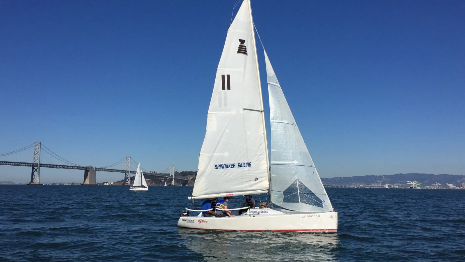 An Andrews 21 sailing on San Francisco Bay with the Bay Bridge behind