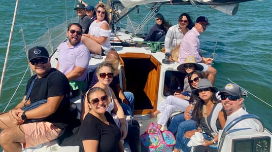 A group of guests relaxing on the deck of the 50-foot yacht Yukon Jack